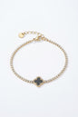 Bracelet Noctis – Trèfle noir et strass en acier doré